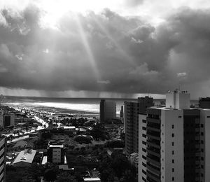 High angle view of buildings by sea against sky