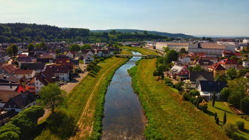 High angle view of river with a bridge and city