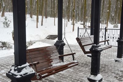 Empty benches in park during winter