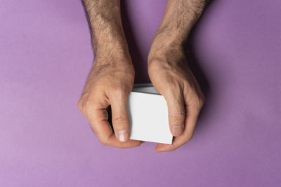 Cropped hand of woman holding paper