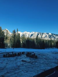 Scenic view of snowcapped mountains against clear blue sky