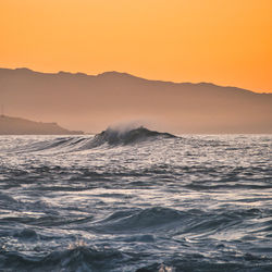 Scenic view of sea against clear sky during sunset