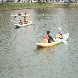 People enjoying in boat sailing in river