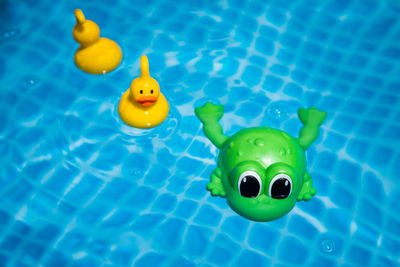 High angle view of yellow toy swimming in pool