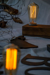 Close-up of illuminated lantern on table