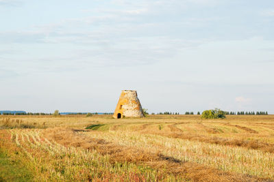  an old dilapidated mill against the backdrop of a summer rural landscape.the concept of tourism