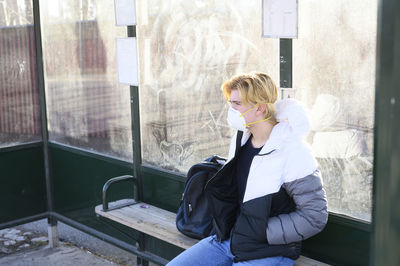 Teenage boy waiting on bus stop