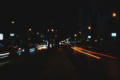 Illuminated city street at night