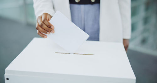 Midsection of woman holding box