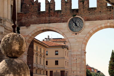 Low angle view of clock on arch wall