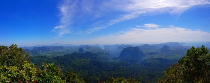 Scenic view of mountains against blue sky