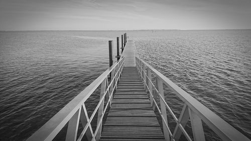 Pier over sea against clear sky