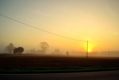 Scenic view of field against sky during sunset