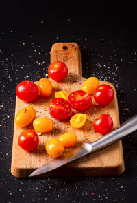 Close-up of fruits in plate against black background