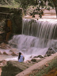 Scenic view of waterfall against trees