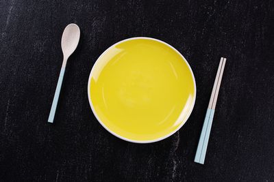 High angle view of yellow and black coffee on table