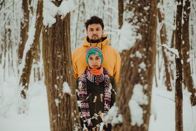 Portrait of young man in forest during winter