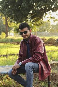 Young man sitting on field