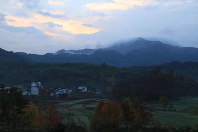 Scenic view of mountains against sky at sunset