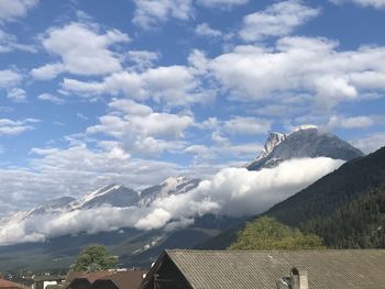 Scenic view of houses and mountains against sky