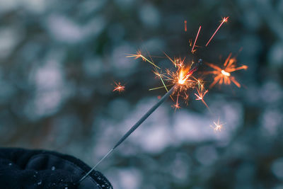 Burning sparklers in a hand outdoors