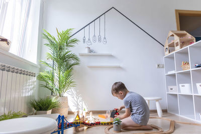 Side view of man using mobile phone at home