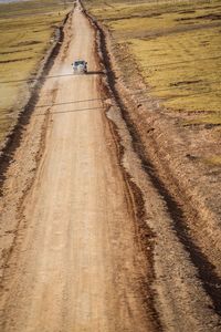 High angle view of tire tracks on field