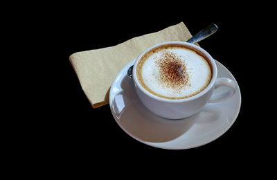 High angle view of coffee cup against black background