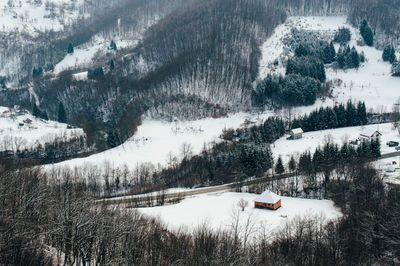 People on snow covered landscape against sky