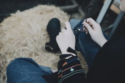 Cropped hands of woman holding eyeglasses