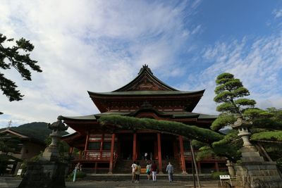 Low angle view of temple against cloudy sky