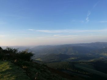 High angle view of countryside landscape against blue sky