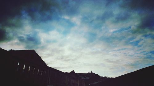 Low angle view of building against cloudy sky