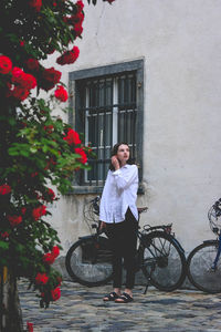 Woman standing by building