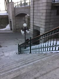 Man standing by railing in winter