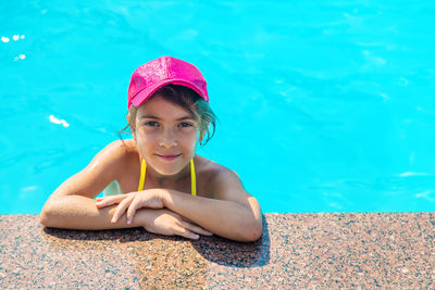 Portrait of girl wearing cap in swimming pool
