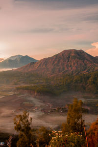 Scenic view of mountains against sky during sunrise