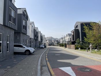 Cars on street against sky