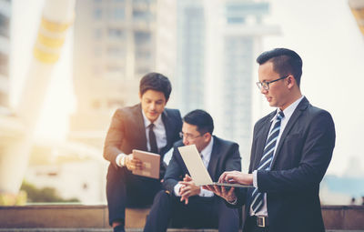 Low angle view of business colleagues on steps against office building