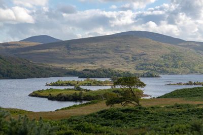 Scenic view of lake and mountains against sky