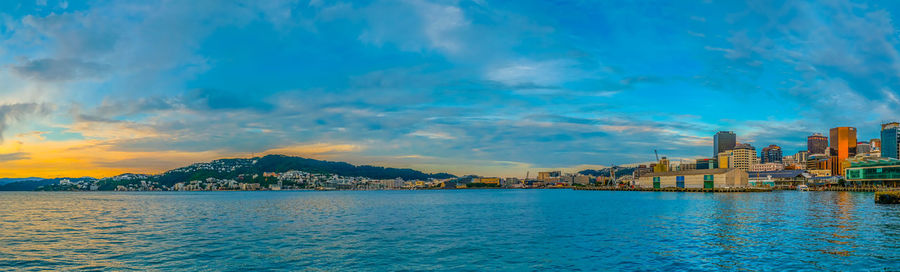 Scenic view of sea and buildings against sky