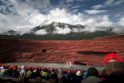 Group of people on mountain range against sky