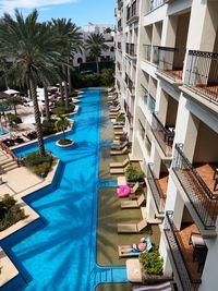 Swimming pool by building against blue sky