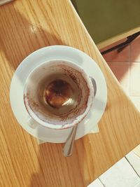 Close-up of coffee cup on wooden table