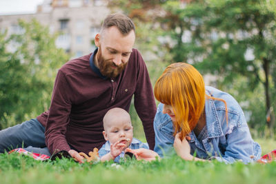 Rear view of father with daughter against plants