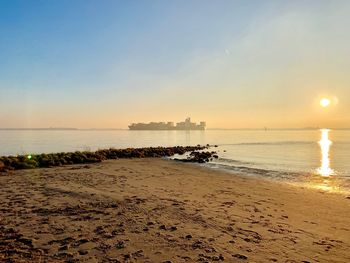 Scenic view of beach against sky during sunset