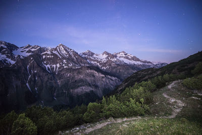 Scenic view of bavarian alps against star field at night