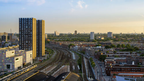 High angle view of road amidst buildings in city against sky