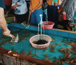 People holding ice cream in basket