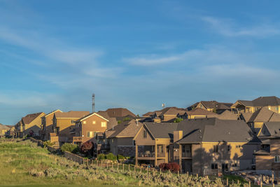 Houses on field against sky